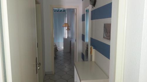 a hallway with a blue and white striped wall at Best Sea View Monte Gordo in Monte Gordo