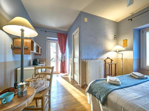 a bedroom with a bed and a table and a dining room at Agriturismo Campoletizia in Miglianico