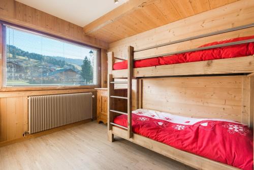 a bedroom with two bunk beds and a window at Cozy chaleett on SLOPES in Crest-Voland