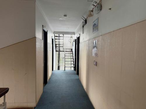a hallway of a building with a stairway at Hyper house hotel in Buôn Ðũng