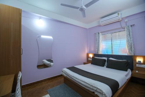 a bedroom with a large bed and a mirror at Nahor Residency in Guwahati