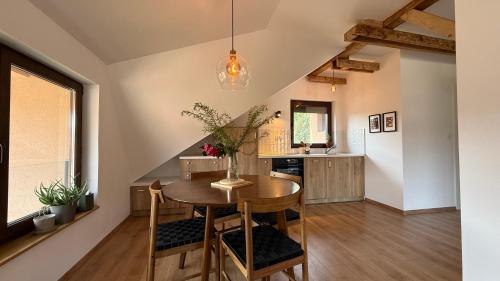 a kitchen and dining room with a table and chairs at Dana apartment with Garden near Tara National Park in Bajina Bašta