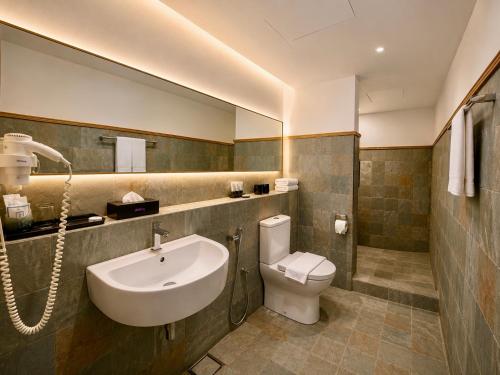 a bathroom with a sink and a toilet at deKing Hotel Twin Towers by DK Hospitality in Kuala Lumpur