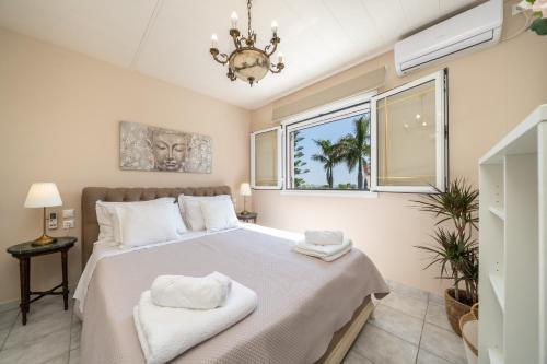 a bedroom with a large bed with towels on it at Gaia Residence in Argostoli