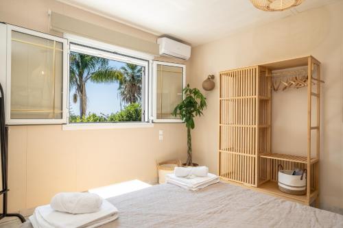 a bedroom with two beds and a window at Gaia Residence in Argostoli