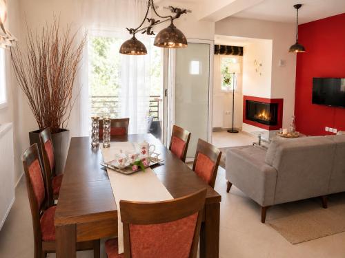 a dining room and living room with a table and chairs at Holiday Lefkas Moonlight Luxury Appartments in Nikiana