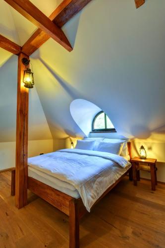 a bed in a room with an attic at Boutique hotel Pod Barborou in Kutná Hora