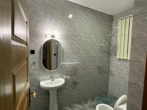 a bathroom with a sink and a mirror at Appartements Rebero Hills in Kigali