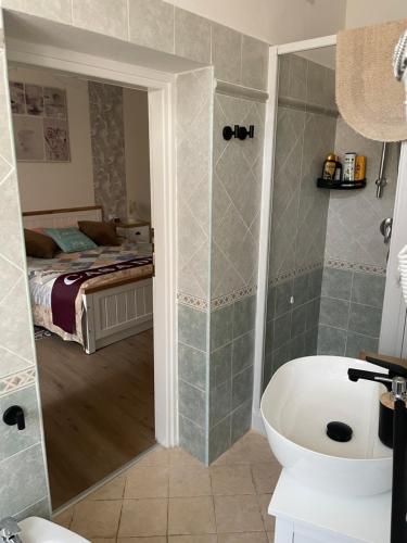 a bathroom with a tub and a bedroom with a bed at La casa di Pi Ta in Sassari