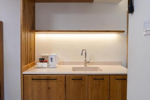 a kitchen with a sink and a light above it at SPNI Ein Gedi Field School in Ein Gedi