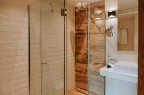 a shower with a glass door in a bathroom at Sivota Diamond Spa Resort in Syvota