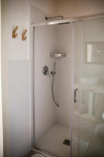 a shower with a glass door in a bathroom at Masseria Voluzzi in Copertino