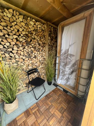 a black chair sitting on a patio with plants at Skansely in Sønderborg