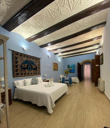 a bedroom with a large white bed in a room at Garden Suites Xativa Casa Rural in Xàtiva