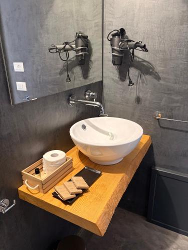 a bathroom with a white sink on a wooden counter at Sea Salt in Terrasini
