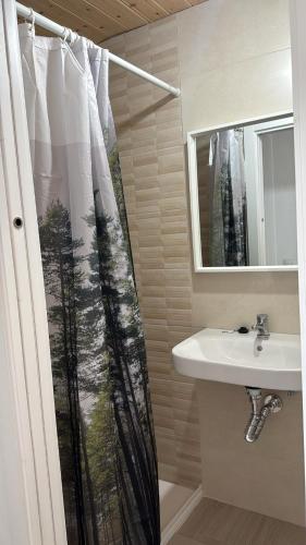 a bathroom with a shower curtain and a sink at VTAR Casa Carmen en Gilena in Gilena