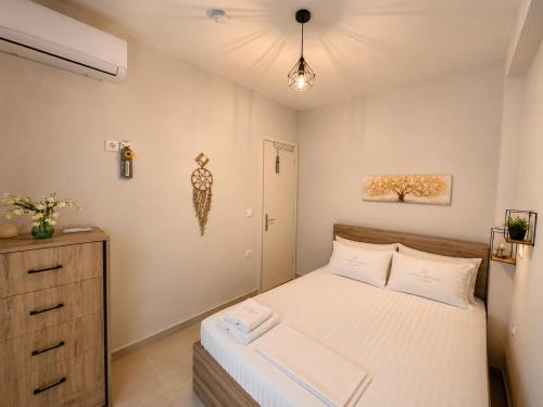 a small bedroom with a bed and a dresser at Crystal 1 Apartment Ofrinio in Ofrínion