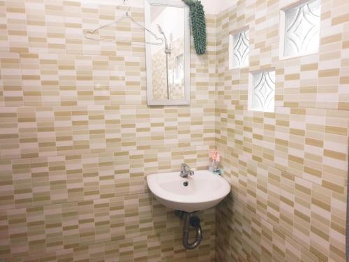 a bathroom with a sink and a mirror and windows at Zena Cottage in Ende