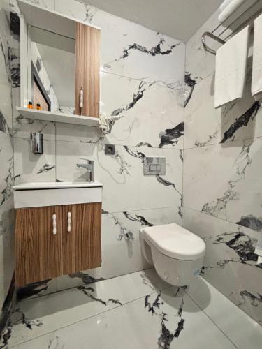 a bathroom with a toilet and a sink at Hisar Çeşme Hotel in Istanbul