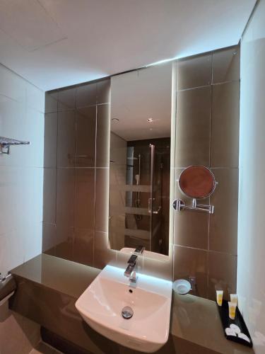 a bathroom with a sink and a mirror at Al Madina Golden Hotel in Medina