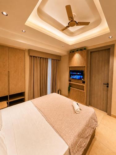 a bedroom with a bed and a ceiling fan at Livora Elite in Ghaziabad