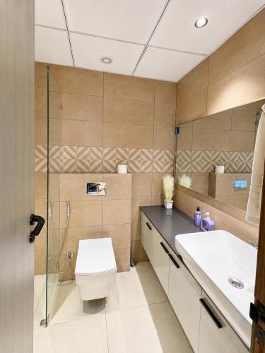 a bathroom with a toilet and a sink at Livora Elite in Ghaziabad