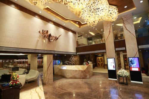 a lobby with a large chandelier in a building at Hotel Park Elanza Chennai in Chennai