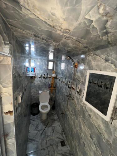 a bathroom with a toilet and a sink at Maison chez Hassan in Wassane