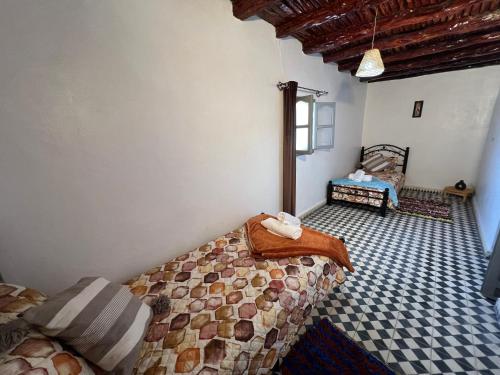 a bedroom with two beds in a room at Maison chez Hassan in Wassane