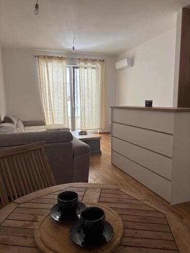 a living room with a couch and a table at Apartment MareMare Budva in Rafailovici