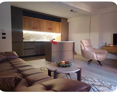 a living room with a couch and a chair at Luxury apartmans in Mavrovo