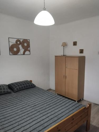 a bedroom with a bed and a wooden cabinet at Vila Jelka in Kremna