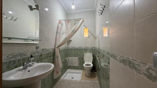 a bathroom with a sink and a toilet at Casa Dina in Ksar es Sghir