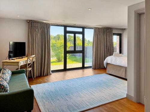 a bedroom with a bed and a desk and a bed and window at Barn Owl Cottage - Uk48510 in Kirk Hammerton