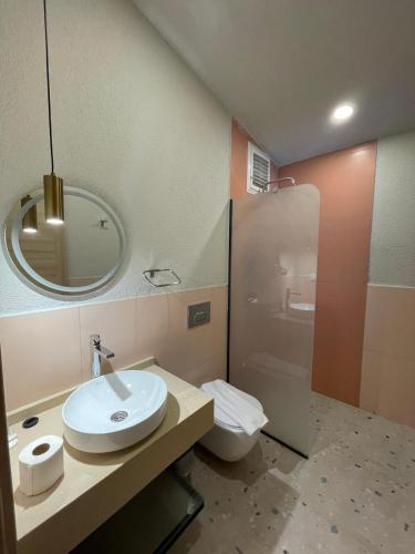 a bathroom with a sink and a toilet and a mirror at Lina Life in Fethiye