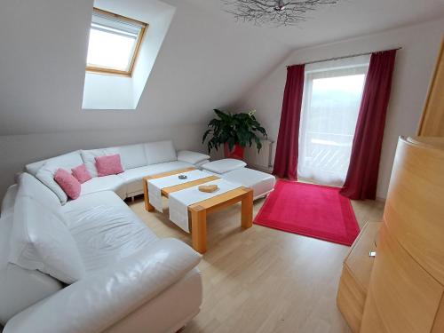 a living room with a white couch and a table at APARTMENT Eva in OBDACH in Obdach