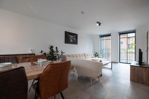 a living room with a table and a couch at Klein Lauw 39 in Tongeren