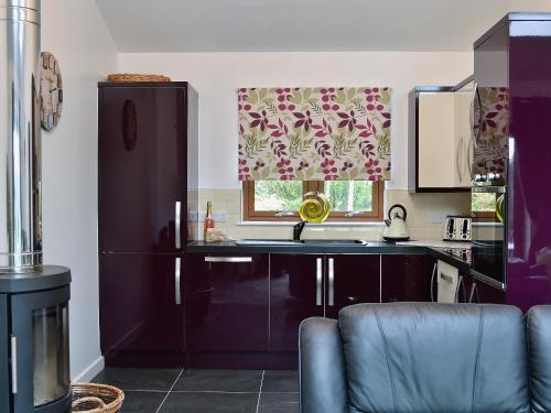 a kitchen with a sink and a window at Mountshade in Finzean