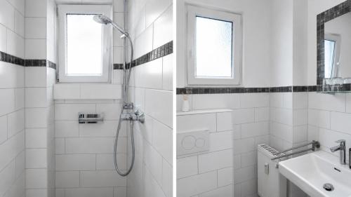 a white bathroom with a shower and a sink at Apartment Falkenstein in Königstein im Taunus