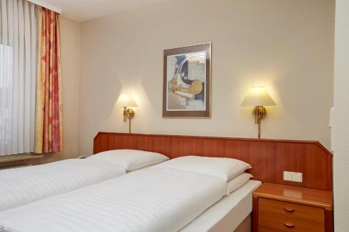 Ein Bett oder Betten in einem Zimmer der Unterkunft Novum Hotel Mannheim City