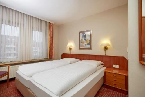 Cama ou camas em um quarto em Novum Hotel Mannheim City