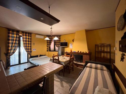 a living room with two beds and a dining room at A Casa del Ferdy in Caserta