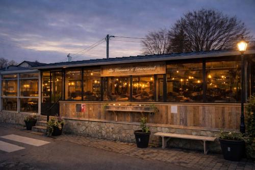 a restaurant with a bench in front of it at Ardennen Karreke in Durbuy