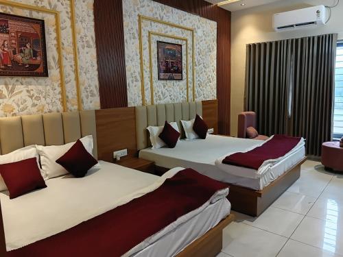 a hotel room with two beds in a room at THE GK Resort in Ābu Road