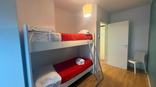 a small room with two bunk beds and a chair at Aurum Aparthotels Bicocca in Milan