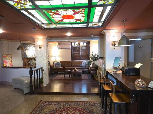 a living room with a couch and a stained glass ceiling at Incheon 레토하우스 in Incheon