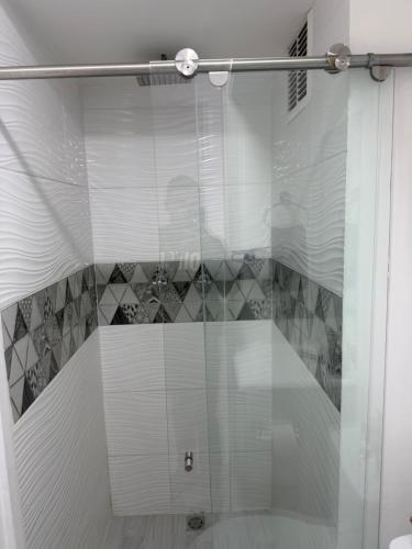 a shower with a glass door in a bathroom at Descanso Ideal in Manizales