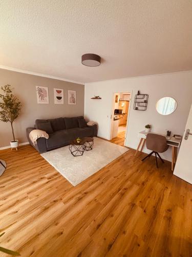 a living room with a couch and a wooden floor at Ferienwohnung De Lorenzi in Boppard