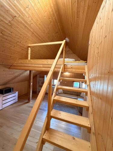 a bunk bed in a cabin with wooden walls at Hostinec U Rypáka in Vrátkov
