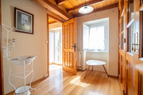 a hallway with a table and a chair in a room at Apartamentos Castello in Cartavio